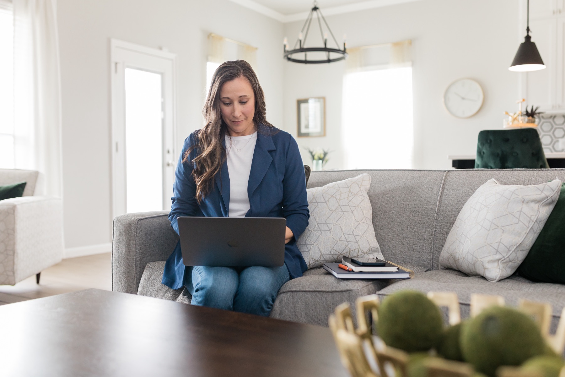 Kari working from her living room with a laptop